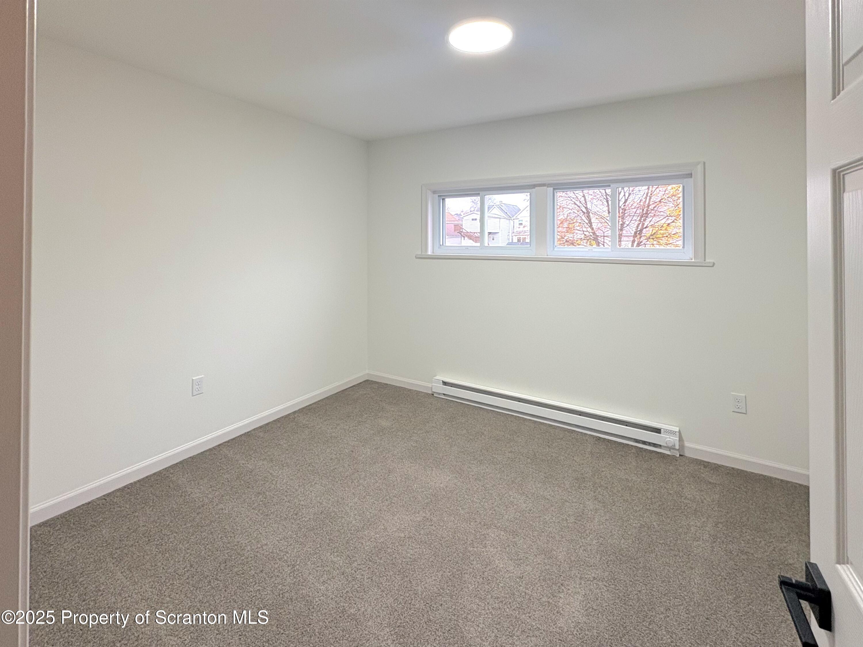 115 West Warren Street Dunmore, PA 18512 - Photo 28 of 36 an empty room with windows