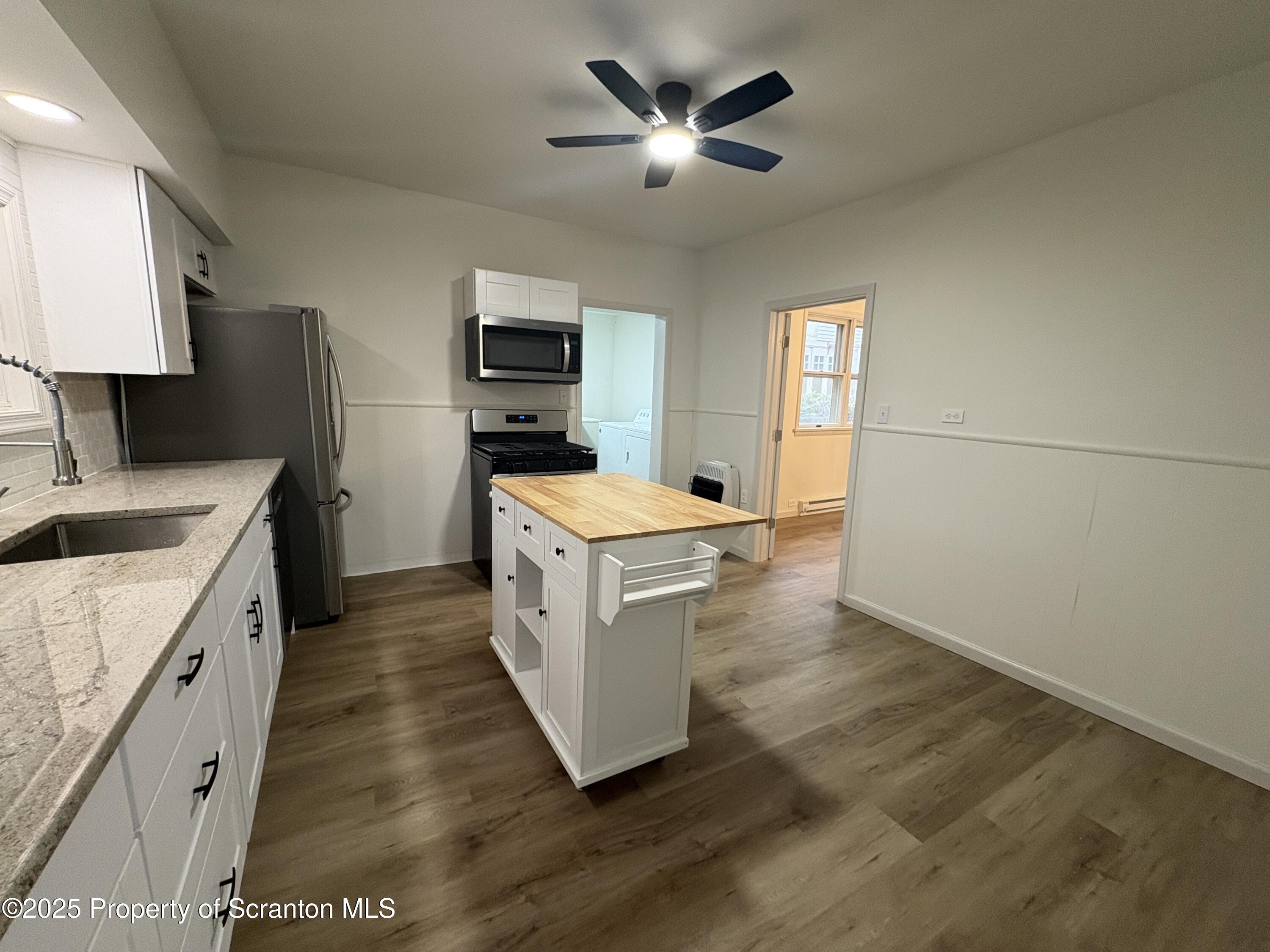 115 West Warren Street Dunmore, PA 18512 - Photo 3 of 36 a kitchen with a stove a sink and a refrigerator
