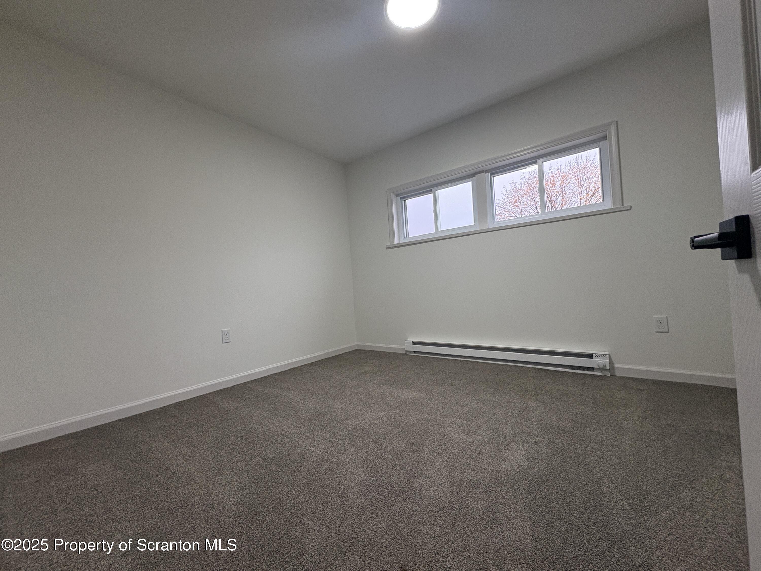 115 West Warren Street Dunmore, PA 18512 - Photo 34 of 36 a view of an empty room with a window