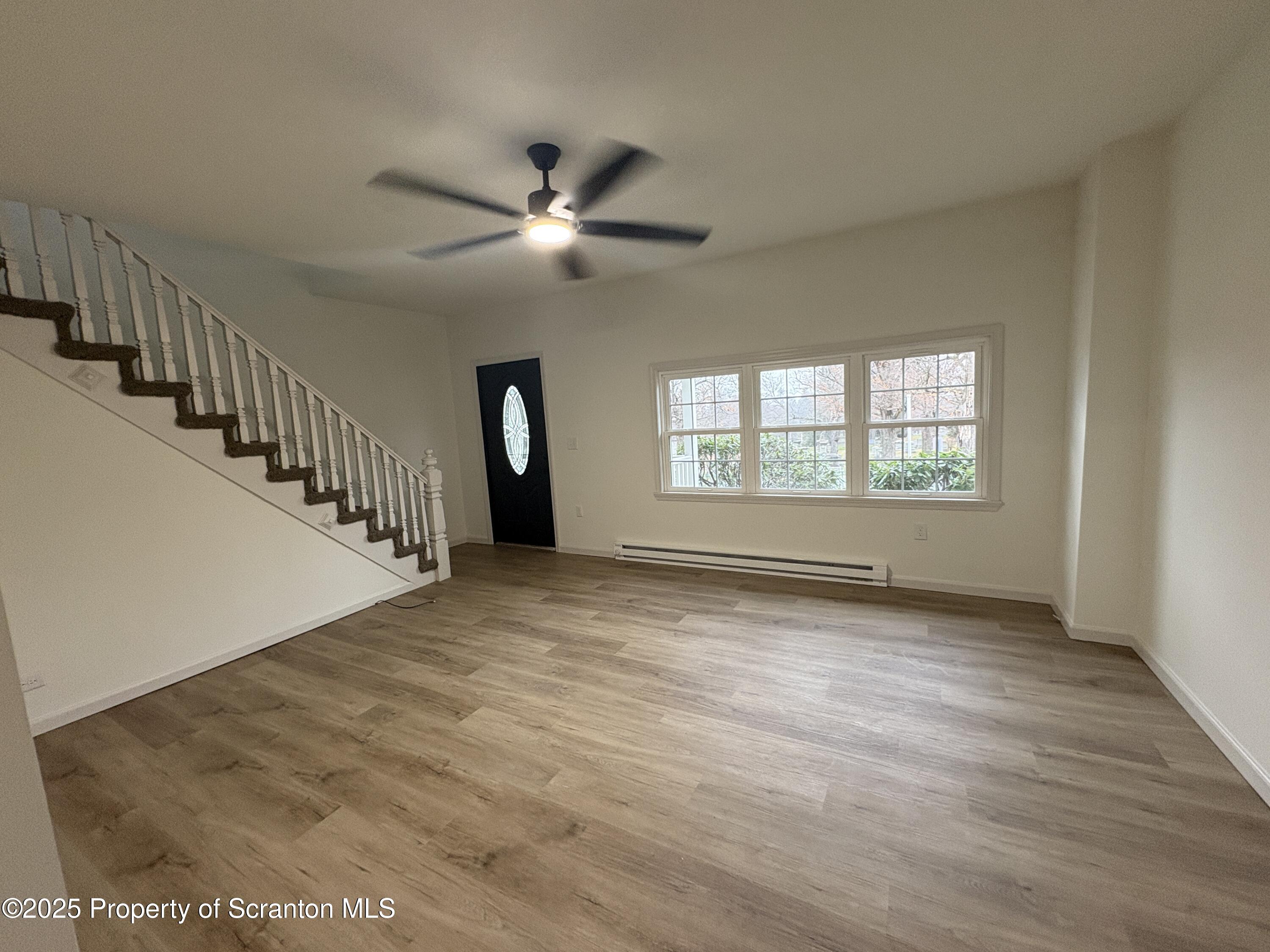 115 West Warren Street Dunmore, PA 18512 - Photo 8 of 36 a view of an empty room with wooden floor and a window