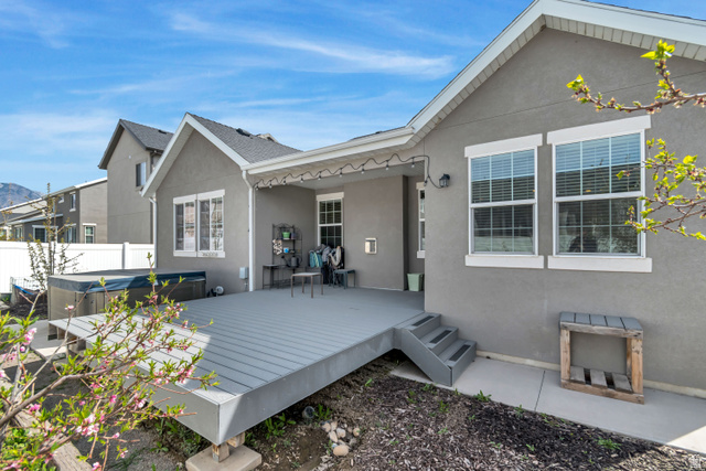 3232 West 1670th Street North Provo, UT 84601 - Photo 4 of 33 Back of house with stucco siding, a hot tub, and a deck