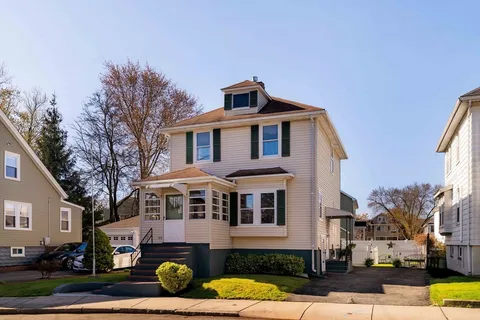 a front view of a house with a yard
