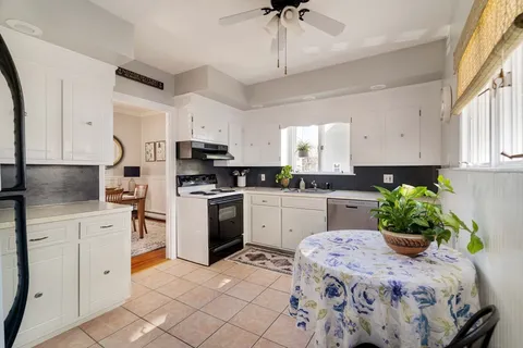a kitchen with a white cabinets and appliances