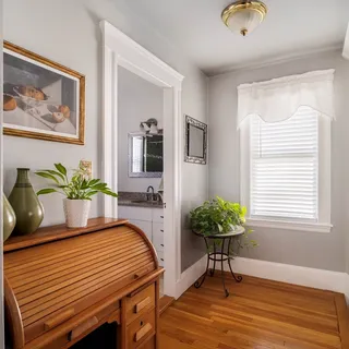 a dining room with furniture and wooden floor