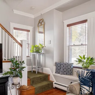 a living room with furniture flowerpot and flower pot