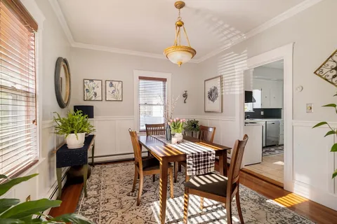 a view of a dining room with furniture window and wooden floor