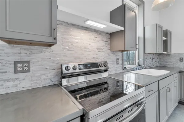 a kitchen with a stove and a sink