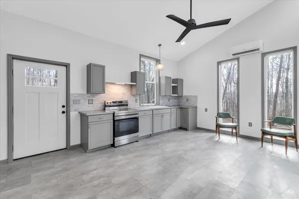 a kitchen with a stove a sink and a refrigerator