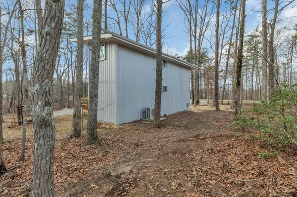 a view of a house with a yard and tree s