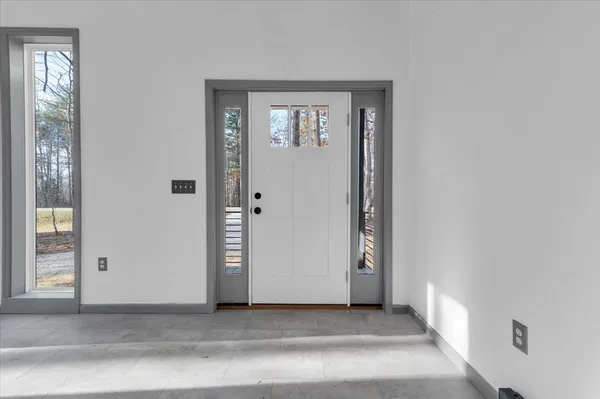 a view of a small space with wooden floor and a window