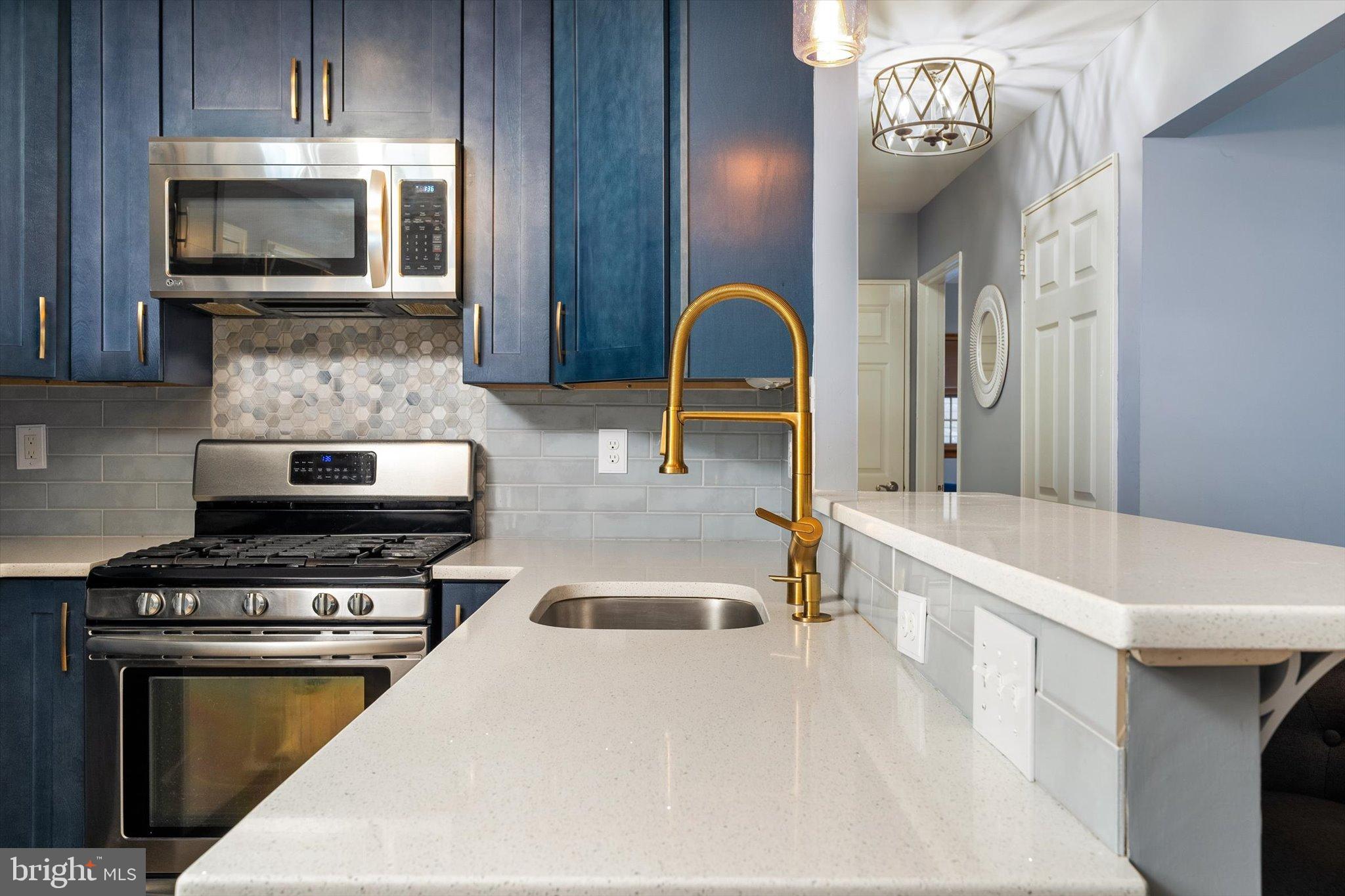23 Beaumont Road Hamilton, NJ 08620 - Photo 13 of 45 a kitchen with a stove and a microwave