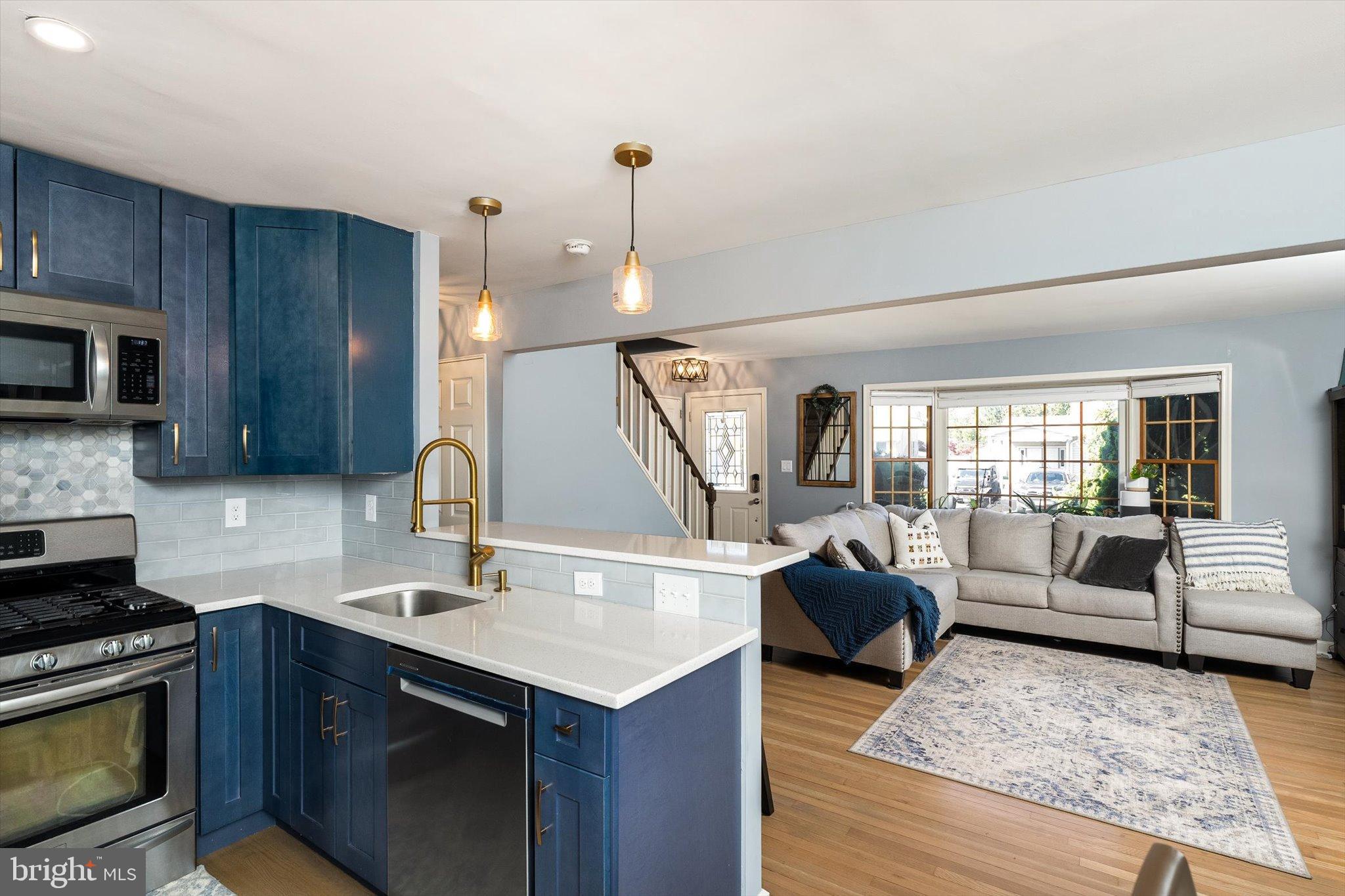 23 Beaumont Road Hamilton, NJ 08620 - Photo 14 of 45 a kitchen with a stove a sink and a wooden floors