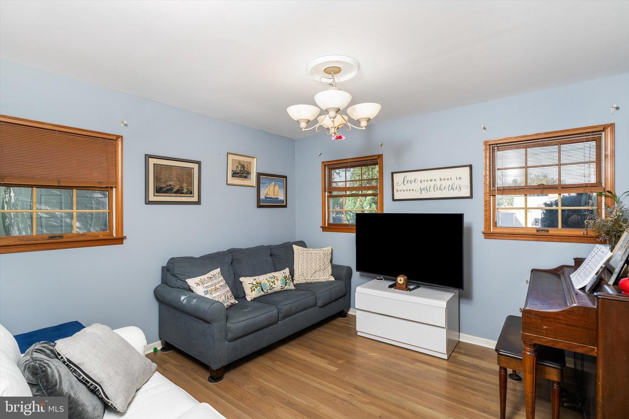 23 Beaumont Road Hamilton, NJ 08620 - Photo 16 of 45 a living room with furniture a flat screen tv and a window