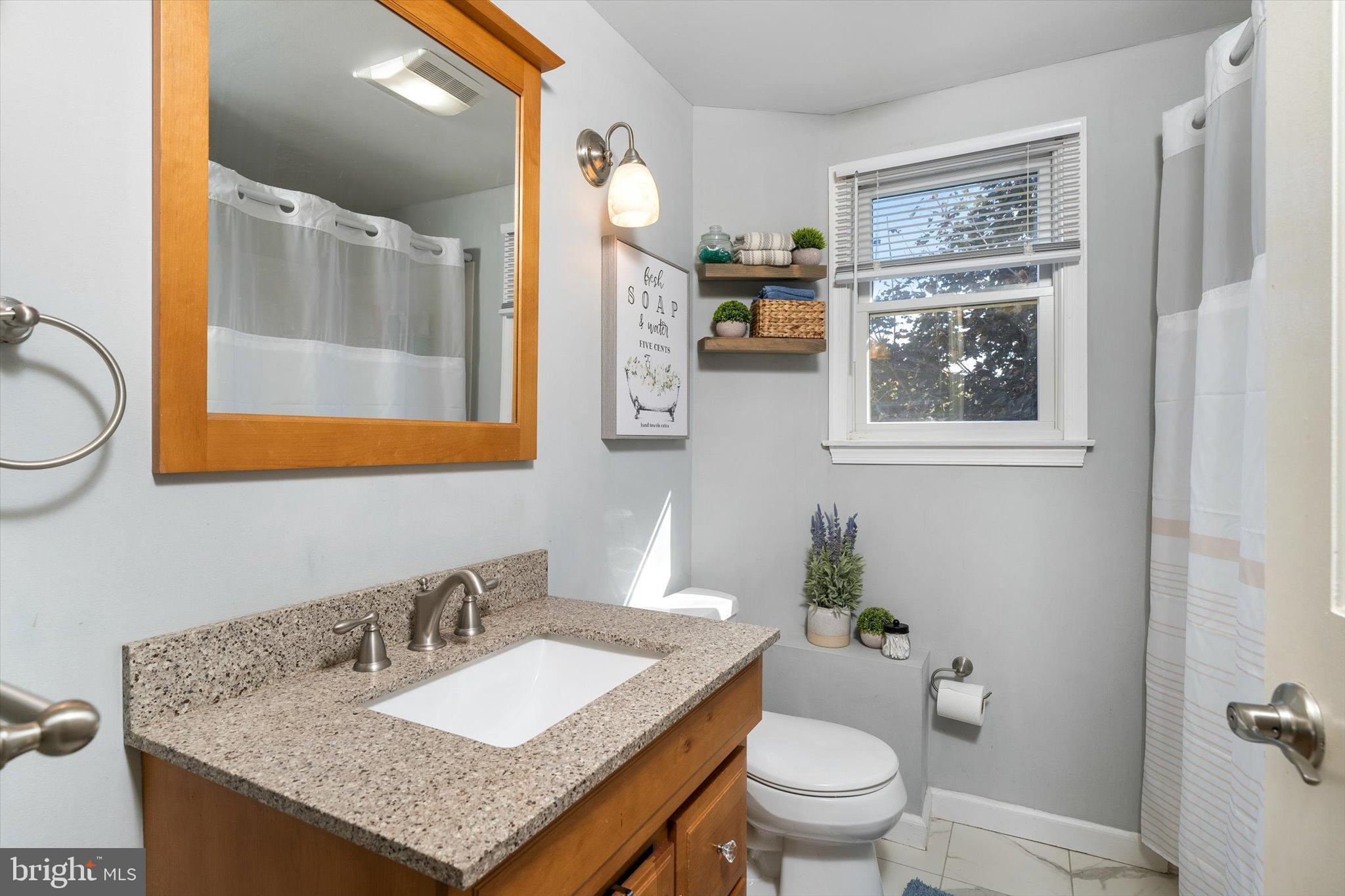 23 Beaumont Road Hamilton, NJ 08620 - Photo 25 of 45 a bathroom with a granite countertop sink and a mirror with toilet