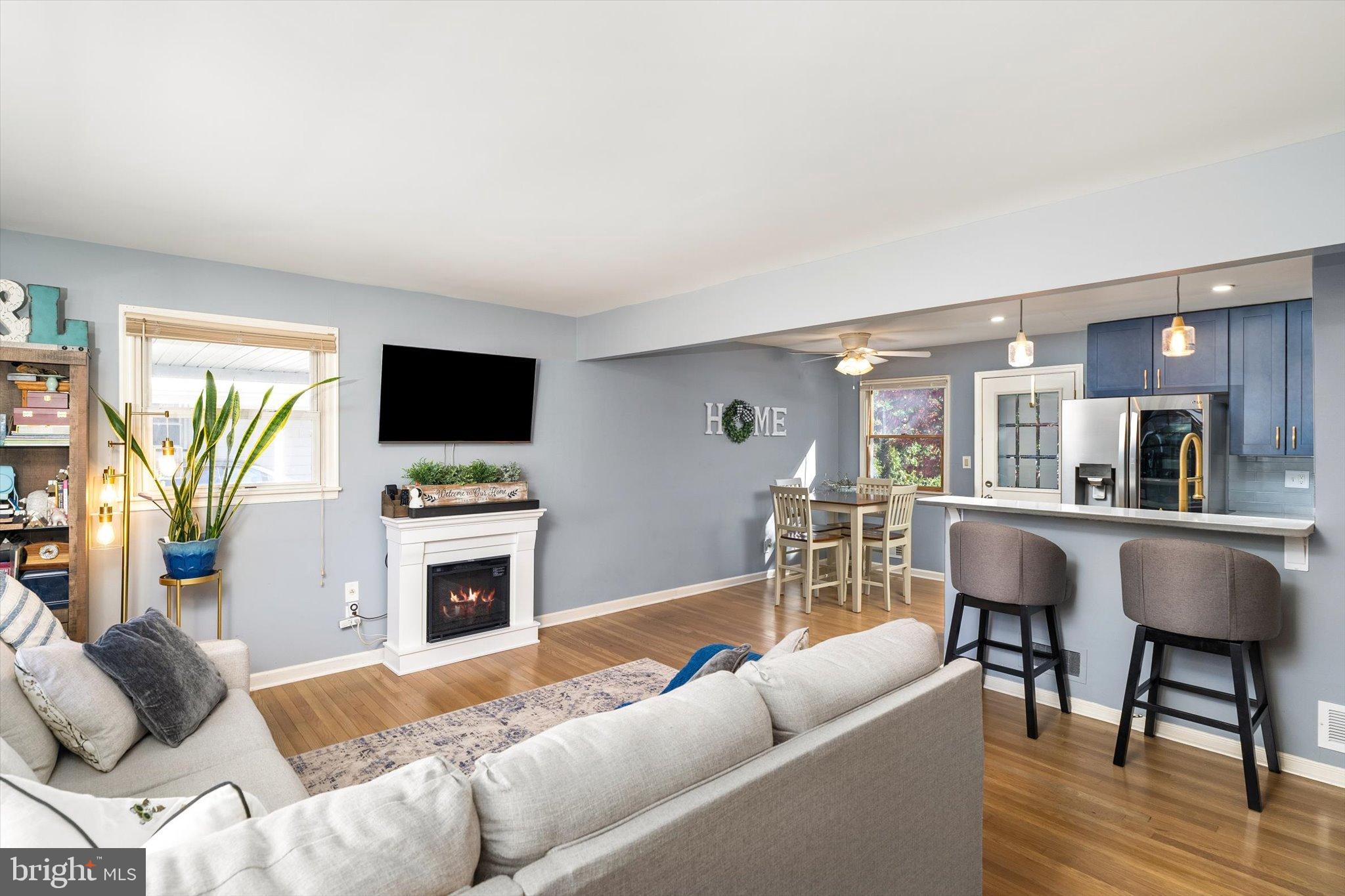 23 Beaumont Road Hamilton, NJ 08620 - Photo 8 of 45 a living room with furniture a fireplace and a flat screen tv