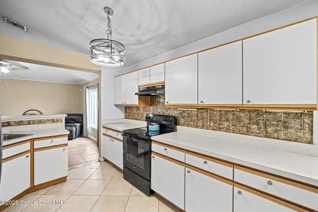 a kitchen with refrigerator and cabinets