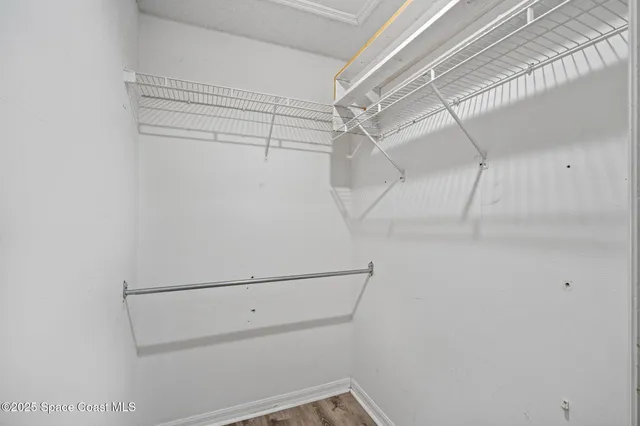 a dining room with furniture large windows and wooden floor
