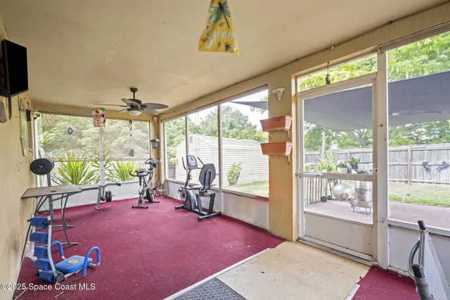 a view of a porch with furniture and garden