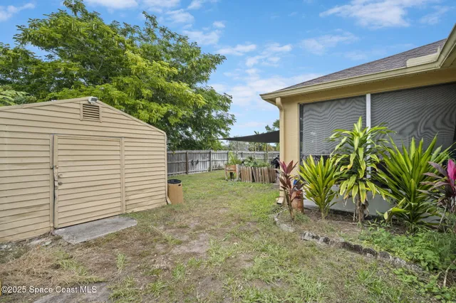 a view of a house with backyard porch and sitting area