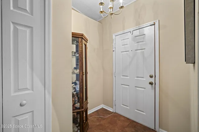 a view of a hallway with wooden floor and closet