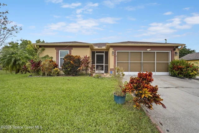 an aerial view of a house with a yard