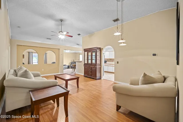 a living room with furniture and kitchen view