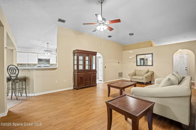 a living room with furniture and wooden floor