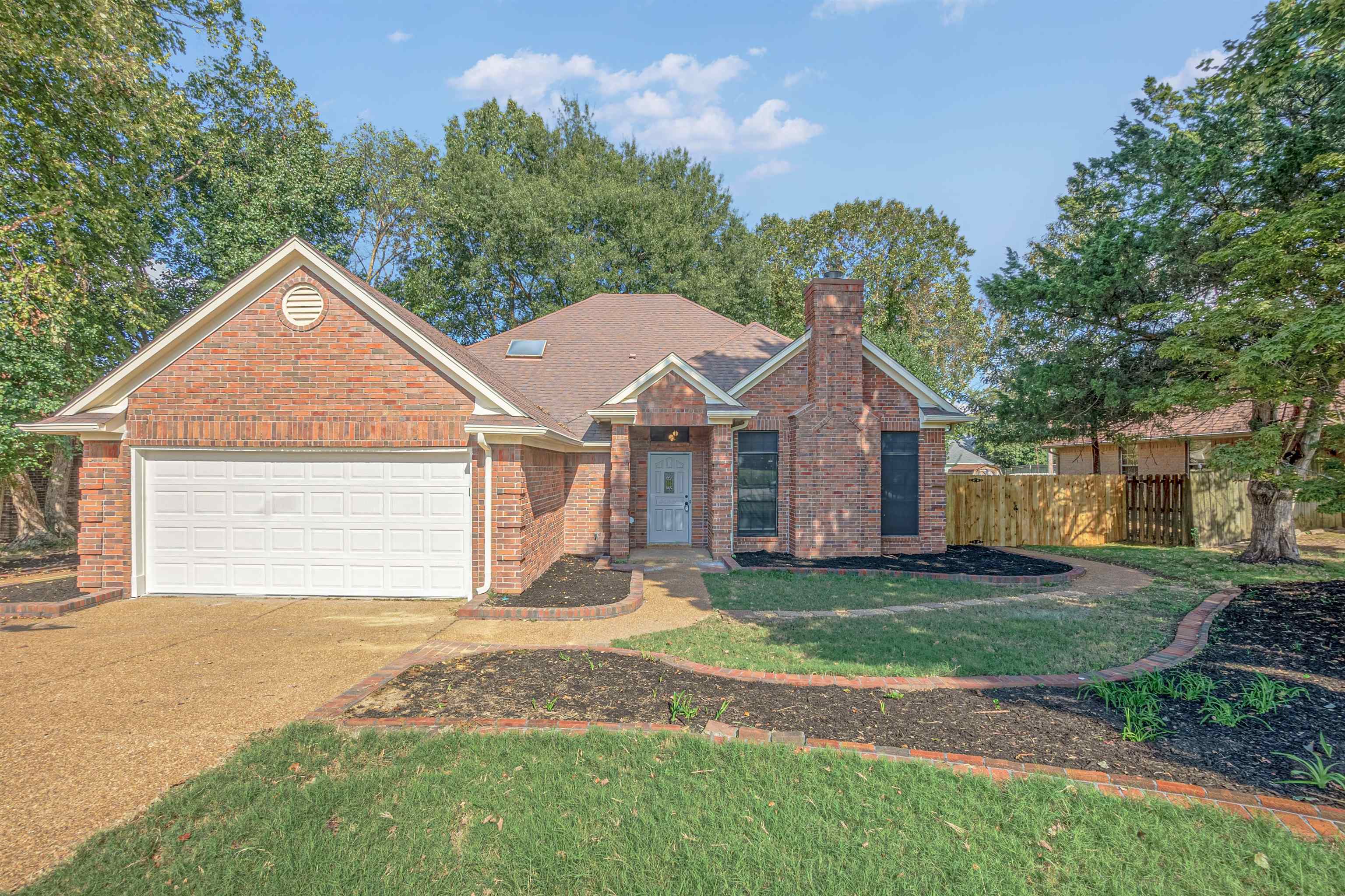 5406 Ross Road Memphis, TN 38141 - Photo 1 of 27 a front view of a house with a yard and garage