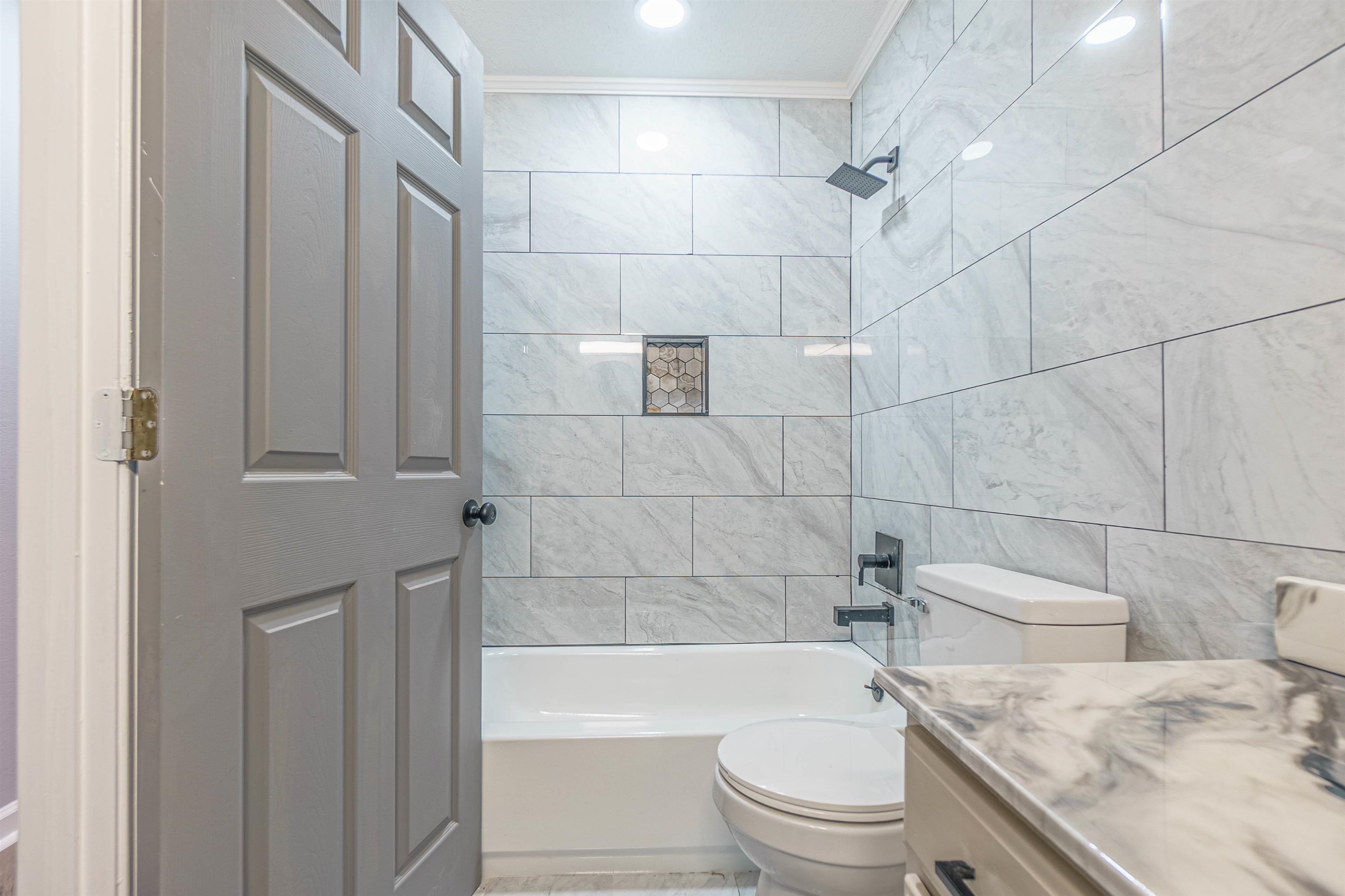 5406 Ross Road Memphis, TN 38141 - Photo 17 of 27 a bathroom with a granite countertop toilet a sink and bathtub