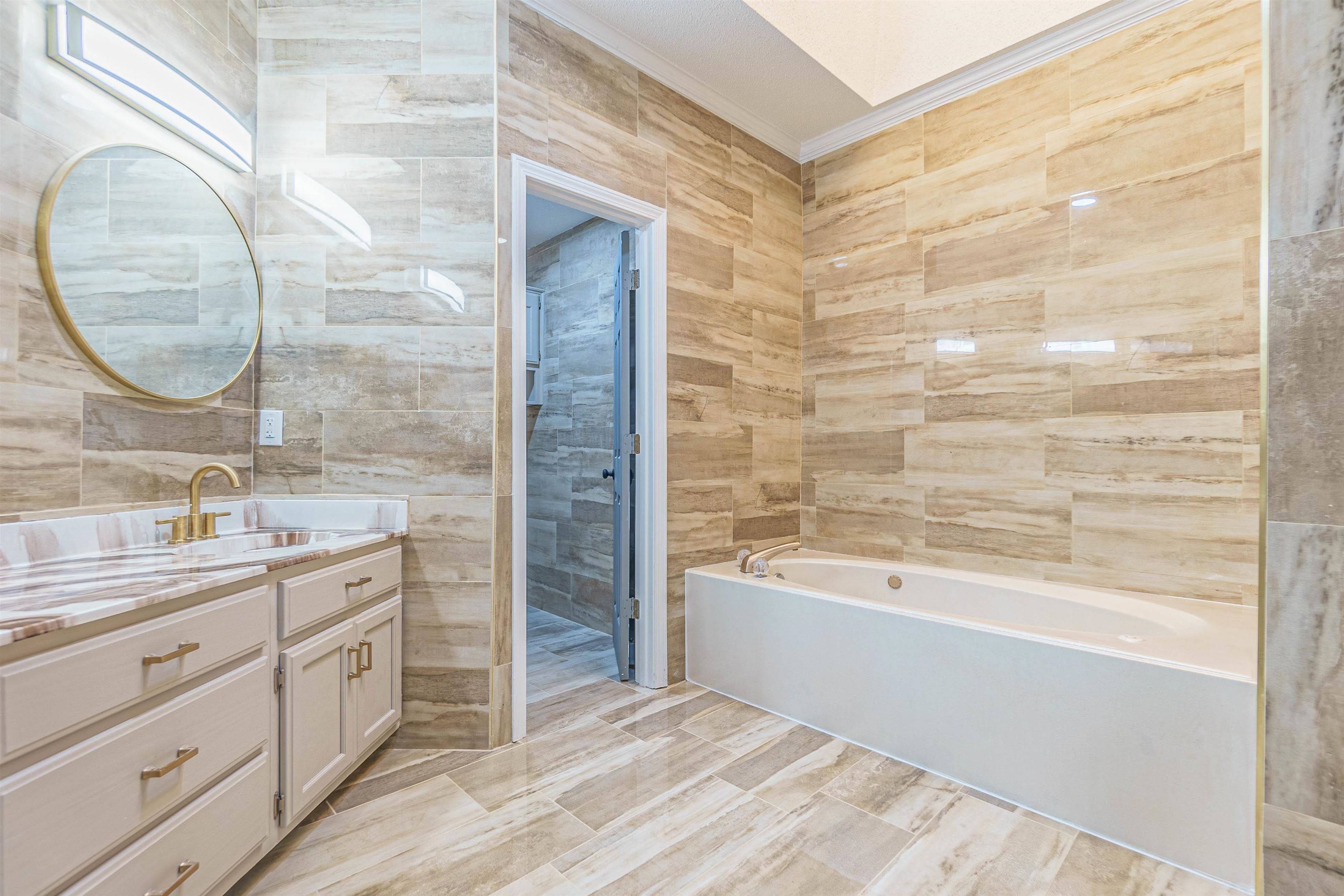 5406 Ross Road Memphis, TN 38141 - Photo 19 of 27 a bathroom with a bathtub and a sink
