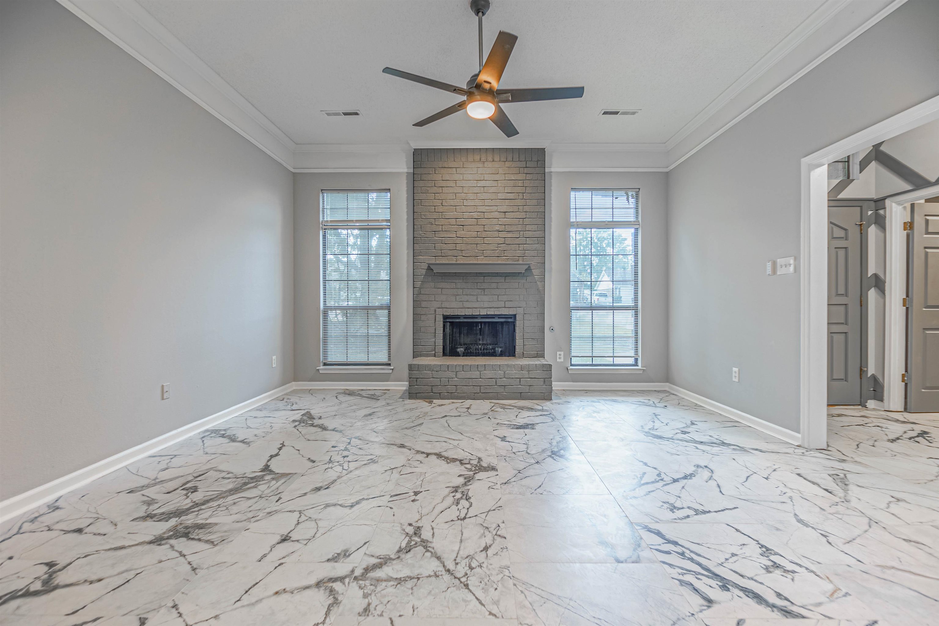 5406 Ross Road Memphis, TN 38141 - Photo 6 of 27 a view of an empty room with a fireplace and a window
