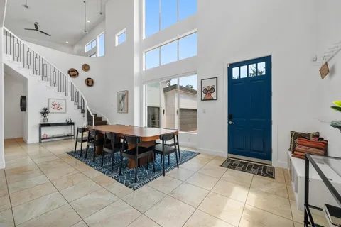 a large kitchen with a table and chairs