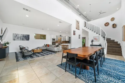 a room with lots of wooden furniture and windows