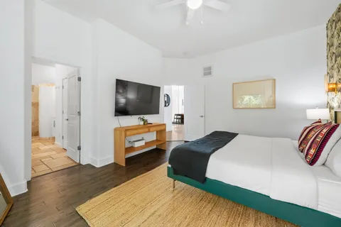 a bedroom with a bed and a flat screen tv