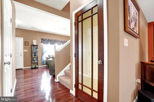 a view of an entryway with wooden floor and stairs