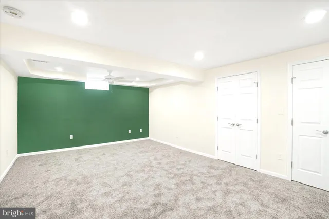 wooden floor in an empty room with a ceiling fan