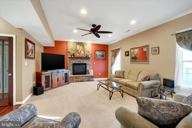 a living room with fireplace furniture and a flat screen tv
