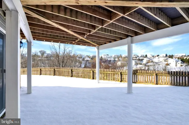 a view of balcony with hardwood floor and lake view