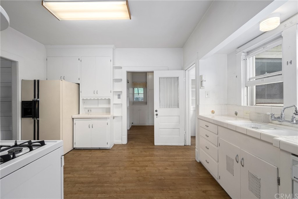 633 East Maple Avenue Orange, CA 92866 - Photo 14 of 51 a kitchen with a sink stove and refrigerator