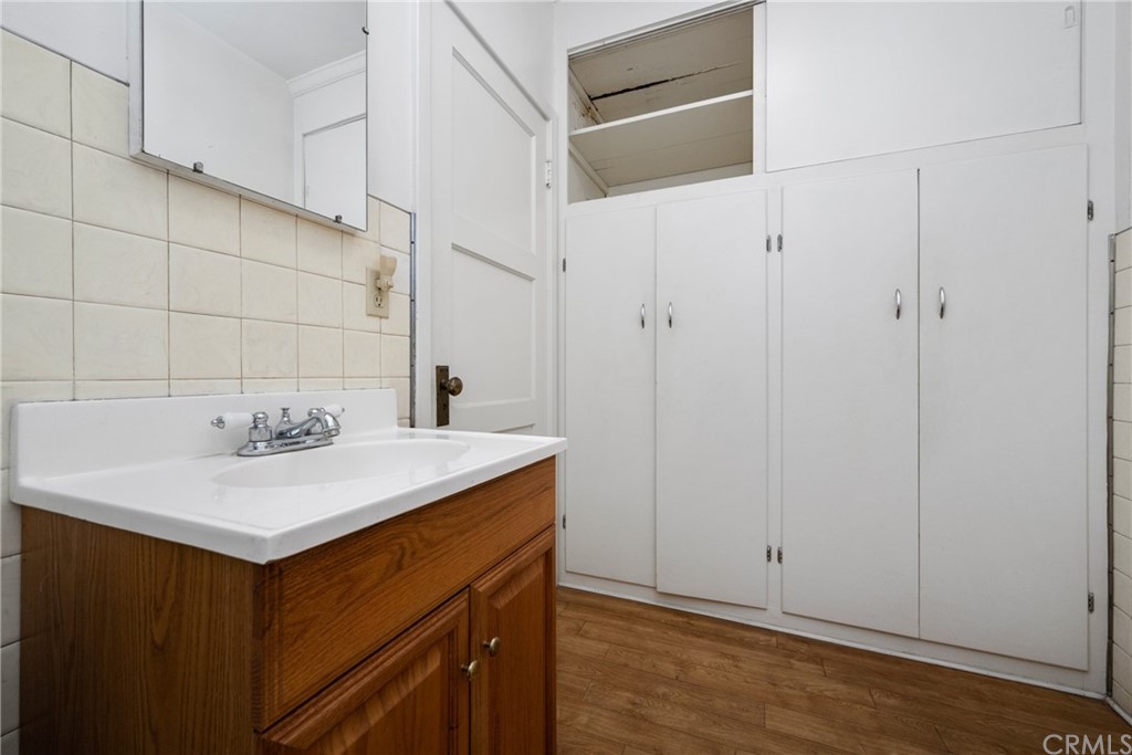 633 East Maple Avenue Orange, CA 92866 - Photo 23 of 51 a kitchen with a sink cabinets and wooden floor