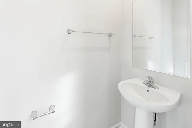 a bathroom with a sink a shower and a mirror