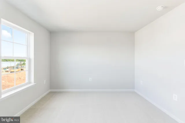 a view of an empty room and a window