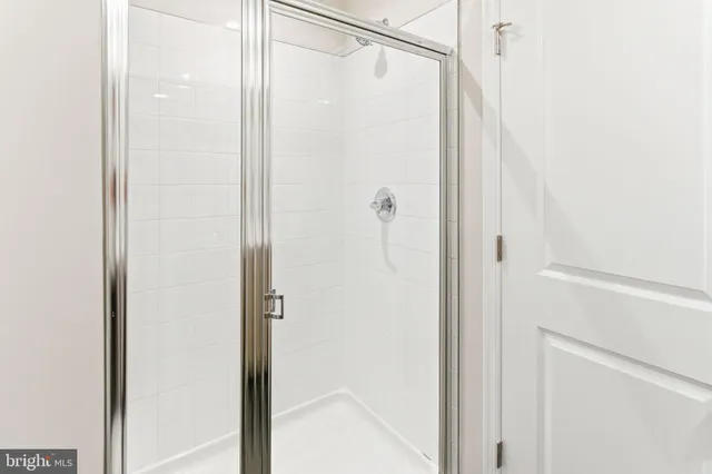 a bathroom with a glass shower door