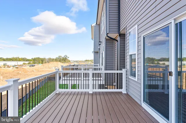 a view of a roof deck with wooden floor and fence