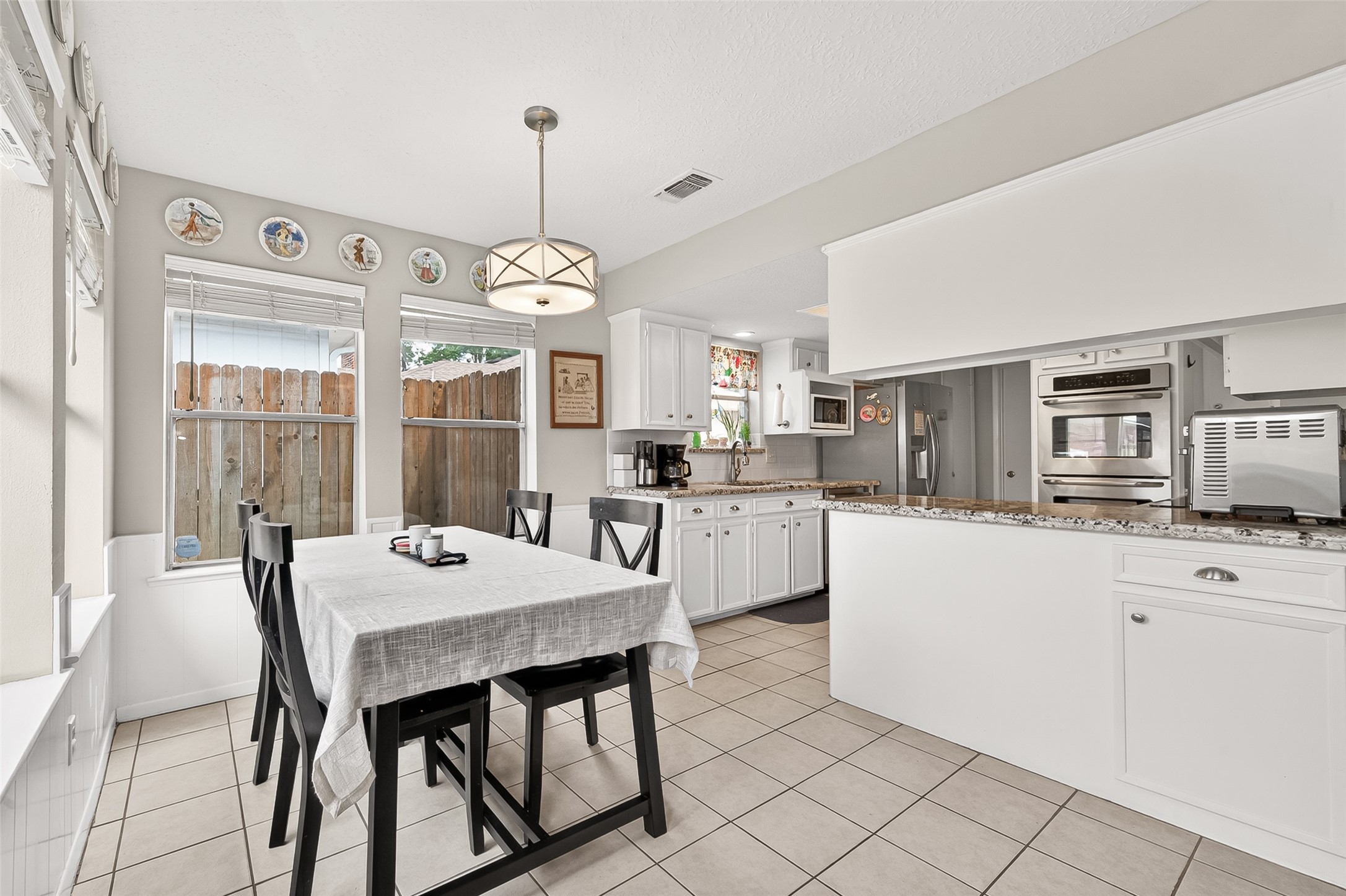 17611 Sorrell Ridge Drive Spring, TX 77388 - Photo 19 of 50 a large kitchen with granite countertop a stove a sink a dining table and chairs