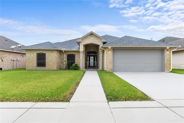 a front view of a house with a yard and garage