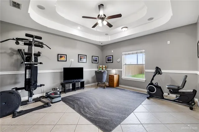 a room with gym equipment and a flat screen tv