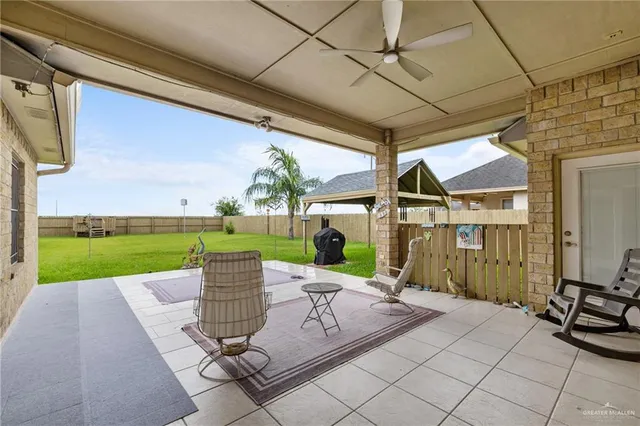 a view of a patio with a table chairs and backyard