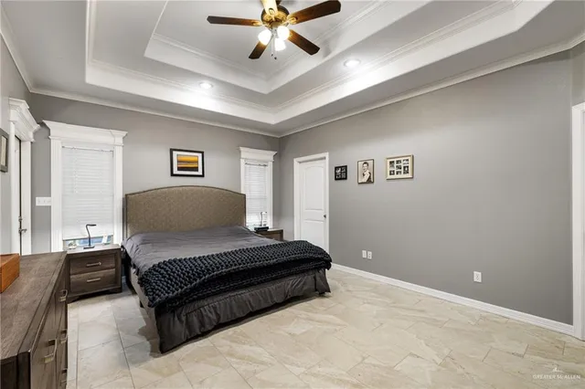 a spacious bedroom with a bed and a ceiling fan