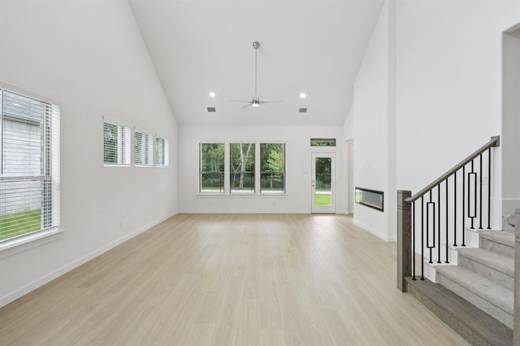 1904 Palmetto Road Celina, TX 75009 - Photo 11 of 32 an empty room with wooden floor and windows